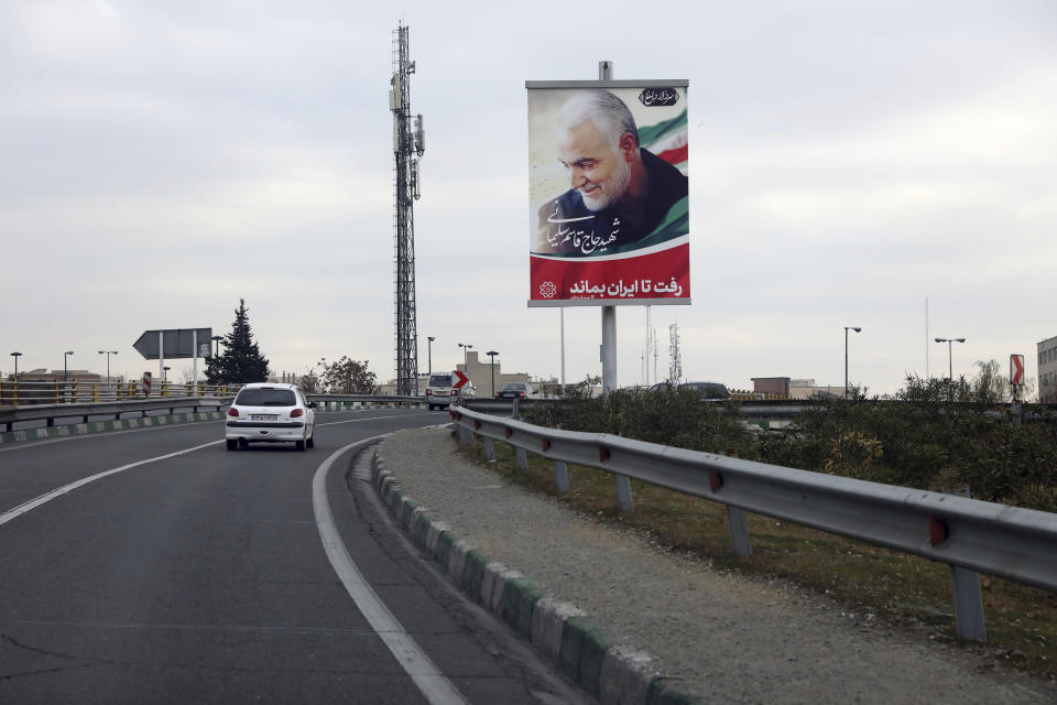 A car drives past a billboard showing a portrait of Iranian Revolutionary Guard Gen. Qassem Soleimani, who was killed in a U.S. airstrike in Iraq, in Tehran, Iran, Saturday, Jan. 4, 2020. The Persian writings in the billboard read: "Martyr Hajj Qassem Soleimani, He went so that Iran can stay." (AP Photo/Vahid Salemi)