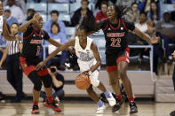 North Carolina guard Shayla Bennett (22) dribbles while Louisville guard Dana Evans (1) and forward Elizabeth Dixon (22) defend during the first half of an NCAA college basketball game in Chapel Hill, N.C., Sunday, Jan. 19, 2020. (AP Photo/Gerry Broome)