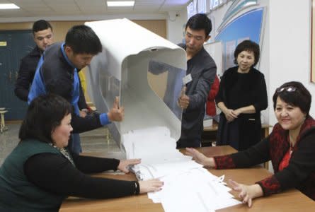 Members of a local electoral commission empty a ballot box at a polling station after a presidential election in Bishkek, Kyrgyzstan October 15, 2017. REUTERS/Vladimir Pirogov