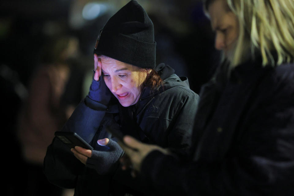 At a protest in Boston, a woman reacts in horror while watching the video of the police attack on Nichols on her cellphone..