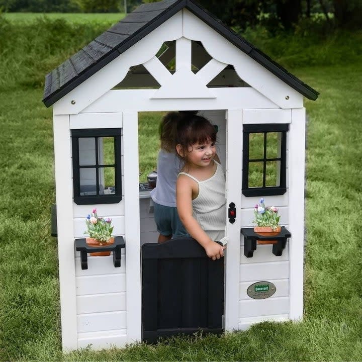 Toddlers play in a playhouse
