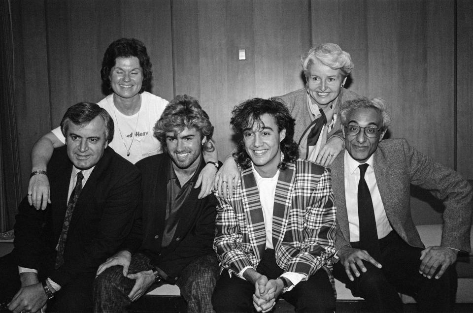 George Michael and Andrew Ridgeley of Wham!, photographed with their parents in 1985 ahead of a tour to China - Mirrorpix 