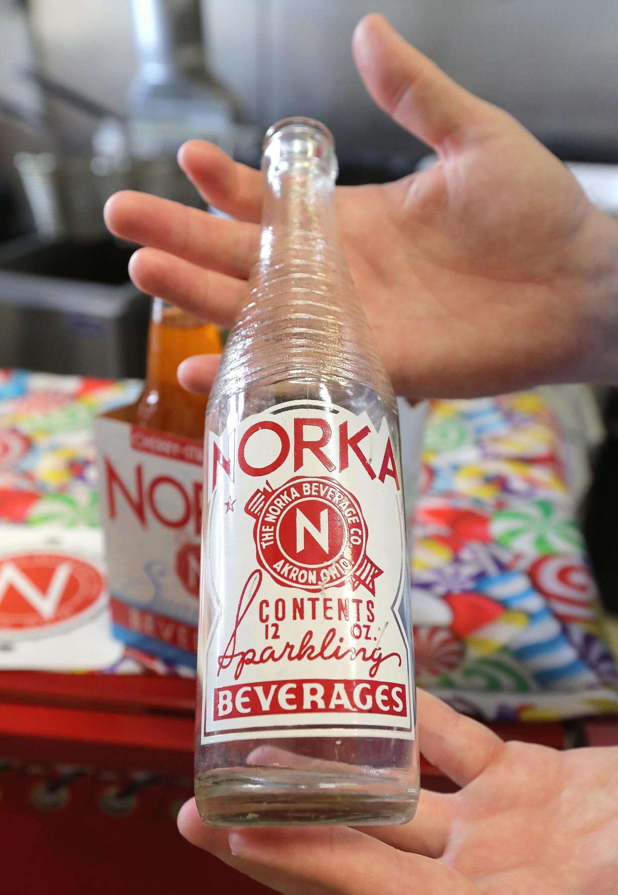 NORKA President Michael Considine shows a bottle of his soft drink from 1953 on Friday, May 3, 2024, in Akron, Ohio. [Phil Masturzo/ Beacon Journal]