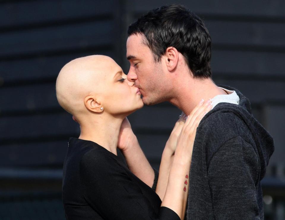 Jade Goody and Jack Tweed share a kiss ahead of their wedding in 2009 (PA)