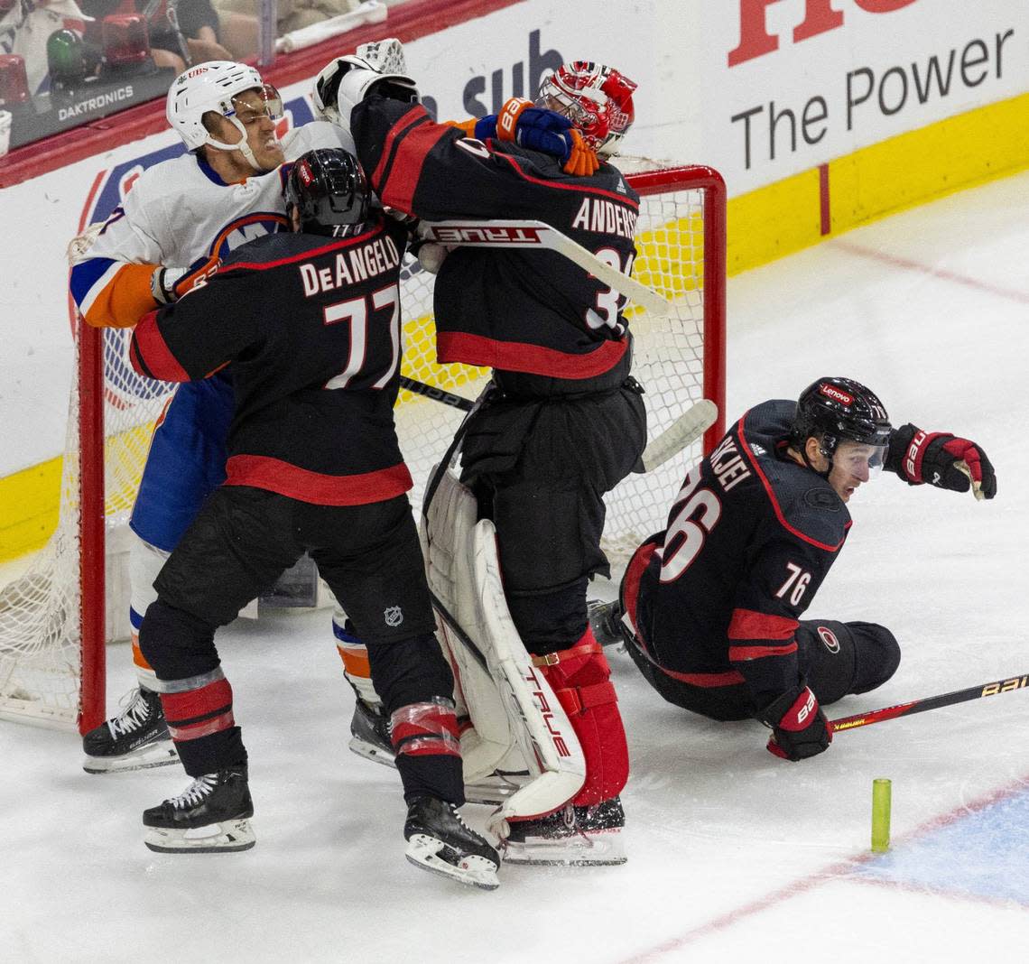 Carolina Hurricanes defenseman Tony DeAngelo (77) and goalie Frederik Anderson (31) fight with New York Islanders left wing Anders Lee (27) in the second period during Game 5 of the NHL Eastern Conference quarterfinals agains the New York Islanders on Tuesday, April 30, 2024 at PNC Arena in Raleigh N.C.