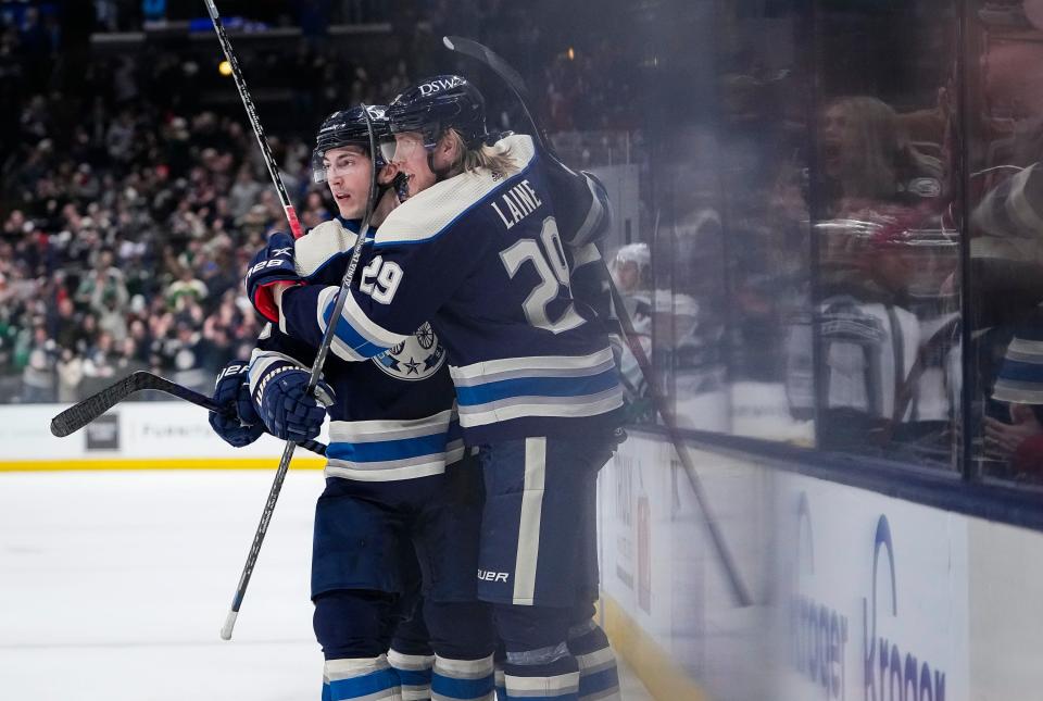 Columbus Blue Jackets left wing Patrik Laine (29) celebrates a goal by defenseman Zach Werenski (8) that tied the game during the third period of the NHL hockey game against the Minnesota Wild at Nationwide Arena in Columbus on March 11, 2022. The Blue Jackets won 3-2 in a shootout.