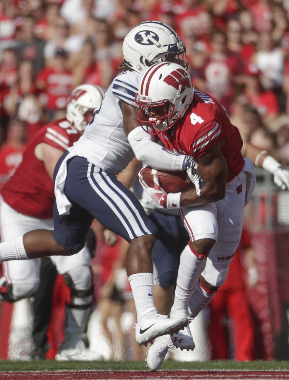 Wisconsin's A.J. Taylor catches a pass in front of BYU's Dayan Ghanwoloku during the first half of an NCAA college football game Saturday, Sept. 15, 2018, in Madison, Wis. (AP Photo/Morry Gash)