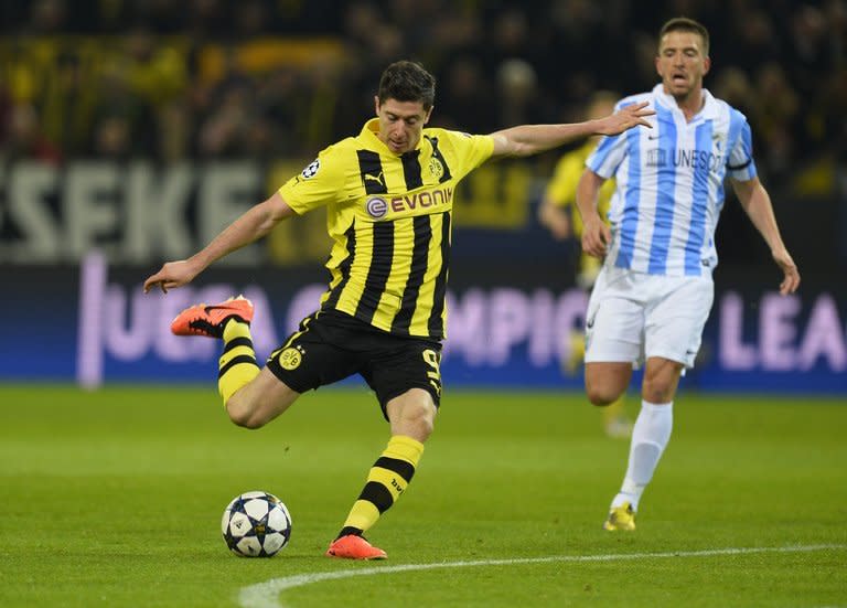 Dortmund striker Robert Lewandowski (L) shoots during their Champions League match against Borussia Dortmund on April 9, 2013. Malaga winger Joaquin had given the Spaniards an early away goal before Lewandowski's equaliser made it 1-1 at the break