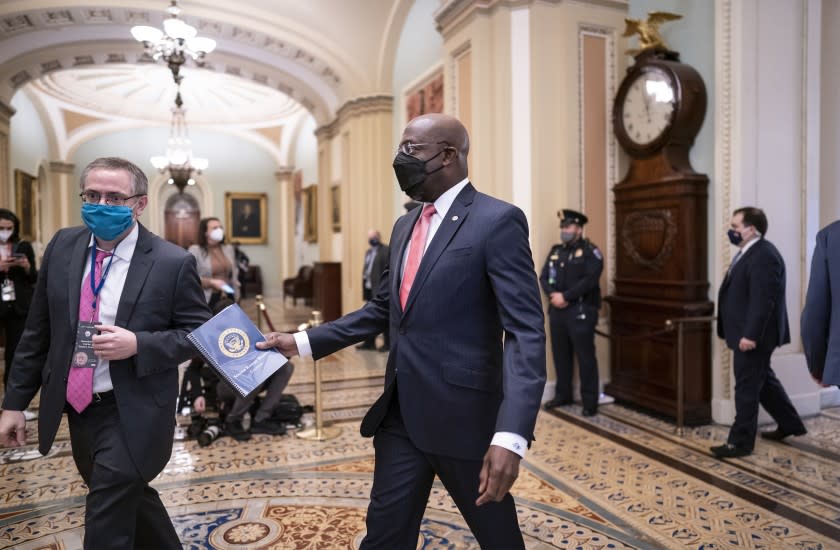 Sen. Raphael Warnock, D-Ga., arrives as the second impeachment trial of former President Donald Trump starts in the Senate, at the Capitol in Washington, Tuesday, Feb. 9, 2021. T(AP Photo/J. Scott Applewhite)