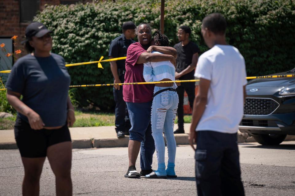 People react to a shooting near Lafayette Park in Detroit on Thursday, July 14, 2022. The shooting occurred near the intersection of E. Larned Street and Orleans Street, according to a tweet from the Detroit Police Department. Police ask that the community stay clear of the area.