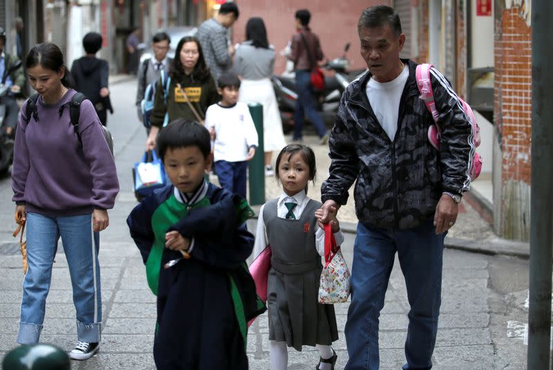 Pupils come back from school, in Macau