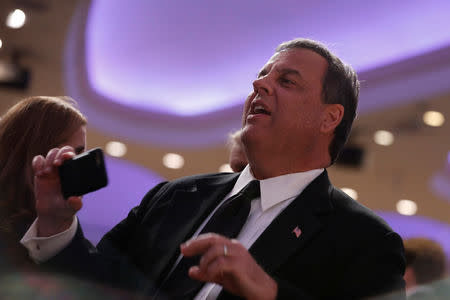 FILE PHOTO: Former New Jersey Governor Chris Christie takes a photo at the White House Correspondents' Association dinner in Washington, U.S., April 28, 2018. REUTERS/Aaron P. Bernstein