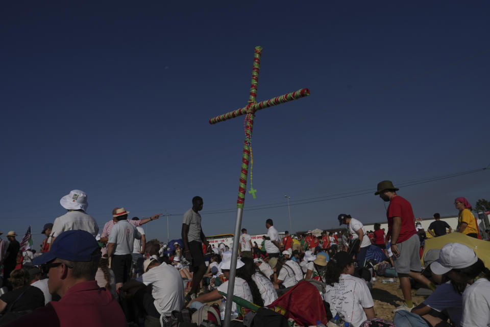 Pilgrims gather at Parque Tejo in Lisbon where Pope Francis is presiding over a mass celebrating the 37th World Youth Day, Sunday, Aug. 6, 2023. An estimated 1.5 million young people filled the parque on Saturday for Pope Francis' World Youth Day vigil, braving scorching heat to secure a spot for the evening prayer and to camp out overnight for his final farewell Mass on Sunday morning. (AP Photo/Ana Brigida)