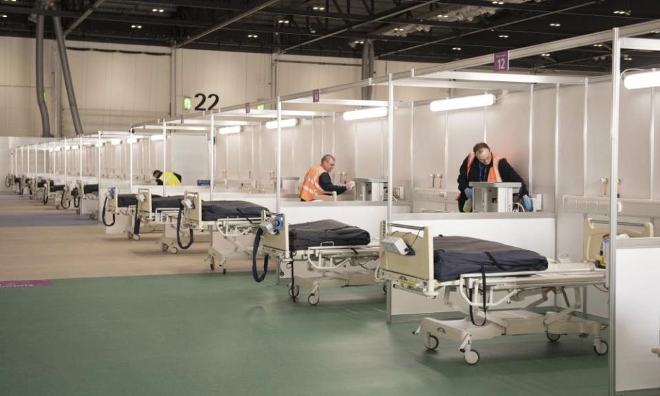 Contractors transform the ExCel centre in east London into the NHS Nightingale hospital in late March.