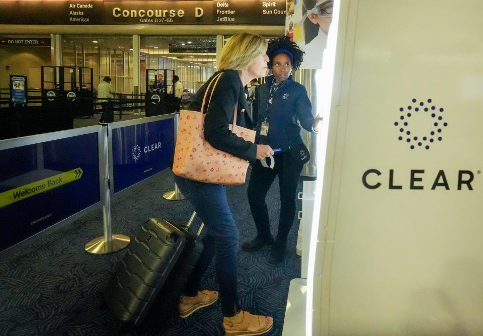 Darla Hargrov watches Sue Mashni use a retinal scan to identify herself using a Clear kiosk Aug. 24 at Mitchell International Airport.