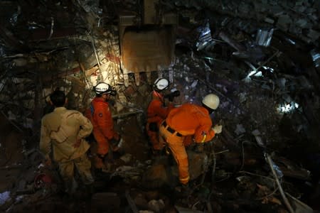 A rescue team attempts to find the missing workers at a collapsed building in Sihanoukville