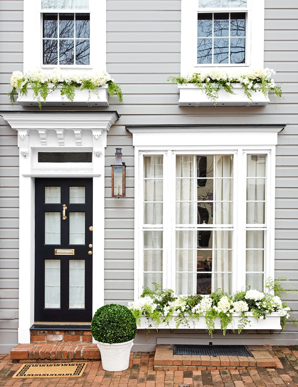 a house with a black door and white windows