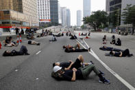 Protesters who camped out overnight take a rest along a main road near the Legislative Council after continuing protest against the unpopular extradition bill in Hong Kong, Monday, June 17, 2019. Hong Kong police and protesters faced off Monday as authorities began trying to clear the streets of a few hundred who remained near the city government headquarters after massive demonstrations that stretched deep into the night before. (AP Photo/Vincent Yu)