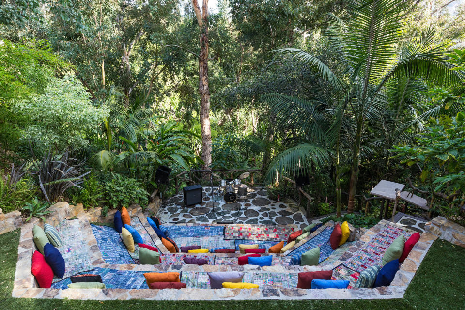 The stone amphitheater has pillows and seat cushions