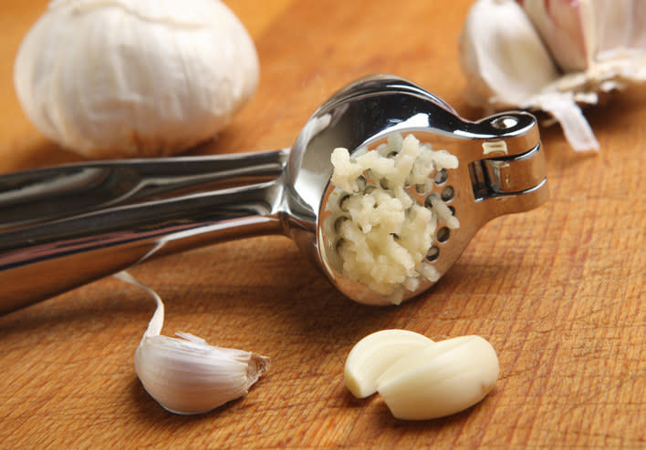 a garlic press with garlic in it