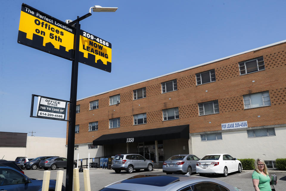 Pedestrians walk outside the former site of what housed an off-campus clinic run by Dr. Richard Strauss, a now-dead Ohio State team doctor, Saturday, May 18, 2019, in Columbus, Ohio. Former nursing student Brian Garrett said he briefly did administrative work at the off-campus clinic but stopped after witnessing abuse by Strauss and then experiencing it himself. "I thought all along he hid that from the university," said Garrett. "Now I find out they actually knew about the off-campus clinic, are you kidding me?" (AP Photo/John Minchillo)