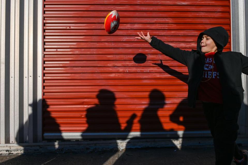 A fan plays football before the parade.<span class="copyright">Eric Thomas—Getty Images</span>