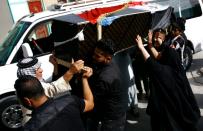 Iraqis carry the coffin of a victim of a car bombing in Sadr City, during a funeral in the holy city of Najaf, on May 11, 2016