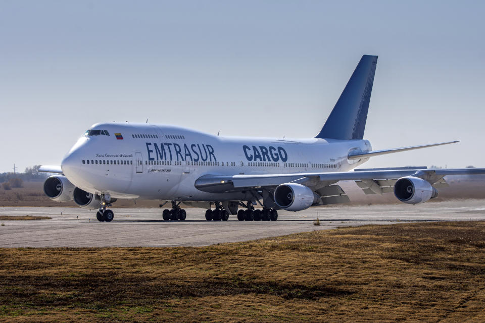 A Venezuelan-owned Boeing 747 taxis on the runway after landing in the Ambrosio Taravella airport in Cordoba, Argentina, Monday, June 6, 2022. Argentine officials are trying to determine what to do with the cargo plane loaded with automotive parts and an unusually large crew of 17, including at least five Iranians. The plane operated by Venezuela's state-owned Emtrasur cargo line has been stuck since June 6 at Buenos Aires' main international airport, unable to depart because of U.S. sanctions against Iran. and suspicions about its crew. (AP Photo/Sebastian Borsero)