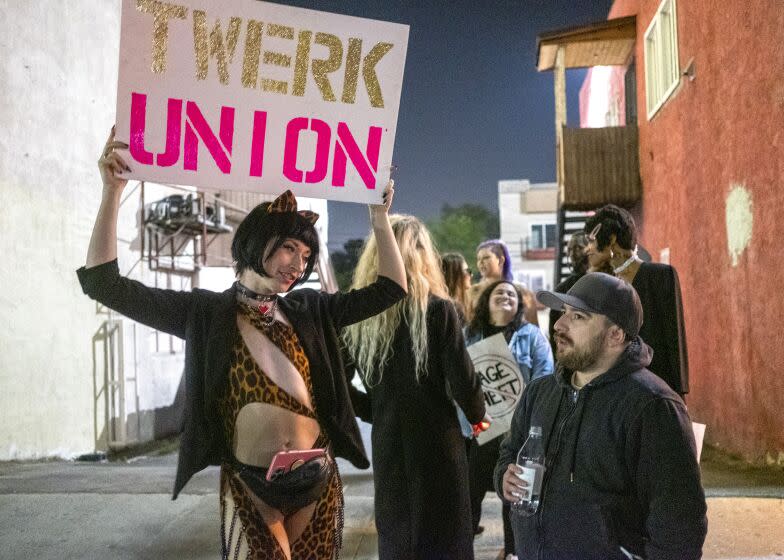 NORTH HOLLYWOOD, CA - MARCH 26: "Reagan" left, is protesting outside Star Garden Topless Dive Bar on Saturday, March 26, 2022 in North Hollywood, CA. Reagan says, "I am so fortunate to be working with such strong women that are not afraid to take a stand on this issue, and make real change happen for us all. I hope we inspire other dancers at other clubs to realize that they can change the industry too, if we stand together for what's right." More than a dozen strippers have been barred from returning to work after they raised concerns regarding their own safety and what they say is the club's management failure to protect them from assault. (Francine Orr / Los Angeles Times)