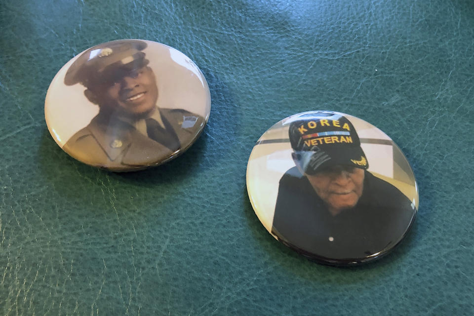 Two buttons handed out to mourners at Alex Leak Jr.'s graveside service sit on an ottoman in his daughter's home in Greensboro, N.C., on Wednesday, Nov. 4, 2020. The Army veteran died in July after collapsing from dehydration at his assisted-living facility, and the family believes pandemic-related neglect is to blame. (AP Photo/Allen G. Breed)