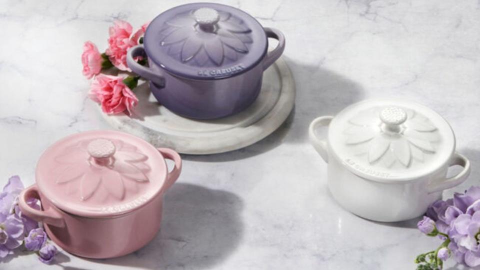 pink, purple and white le creuset mini cocottes with flower lids. 