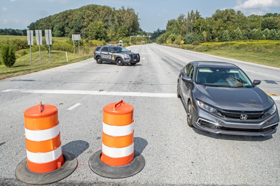 A Pennsylvania state trooper patrols at Lenape Road and Baltimore Pike near Longwood Gardens, near Kennett Square, Pa., during the manhunt for escaped convicted murderer Danelo Cavalcante on Friday, Sept. 8, 2023.
