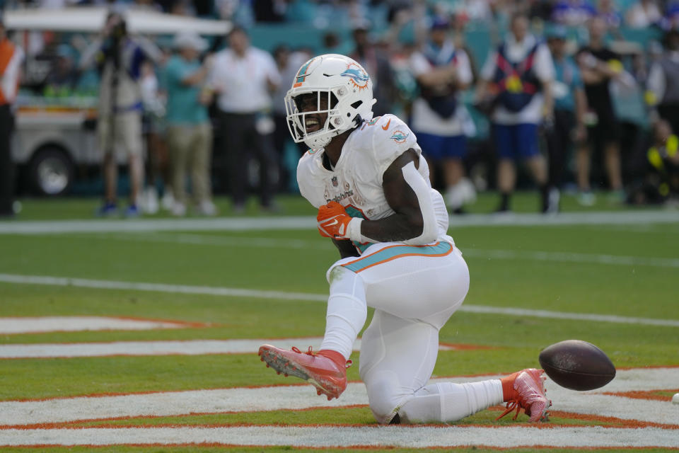 Miami Dolphins running back Chase Edmonds (2) celebrates a touchdown during the second half of an NFL football game against the Buffalo Bills, Sunday, Sept. 25, 2022, in Miami Gardens, Fla. (AP Photo/Rebecca Blackwell)