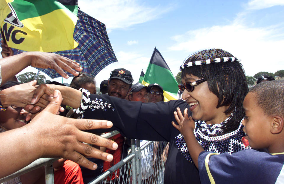 <p>African National Congress (ANC) Womens League President Winnie Madikizela-Mandela greets supporters at the closing rally of the 51st National Conference of the ruling ANC on Dec. 20, 2002.<br> Madikizela-Mandela was elected to a new term on the top decision-making body of the ANC, the National Executive Committee, along with both the secretary general and deputy secretary general of the South African Communist Party. (Photo: Mike Hutchings/Reuters) </p>