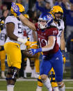 Kansas linebacker Gavin Potter (19) celebrates a fumble recovery against West Virginia during the first quarter of an NCAA college football game Saturday, Nov. 27, 2021, in Lawrence, Kan. (AP Photo/Ed Zurga)