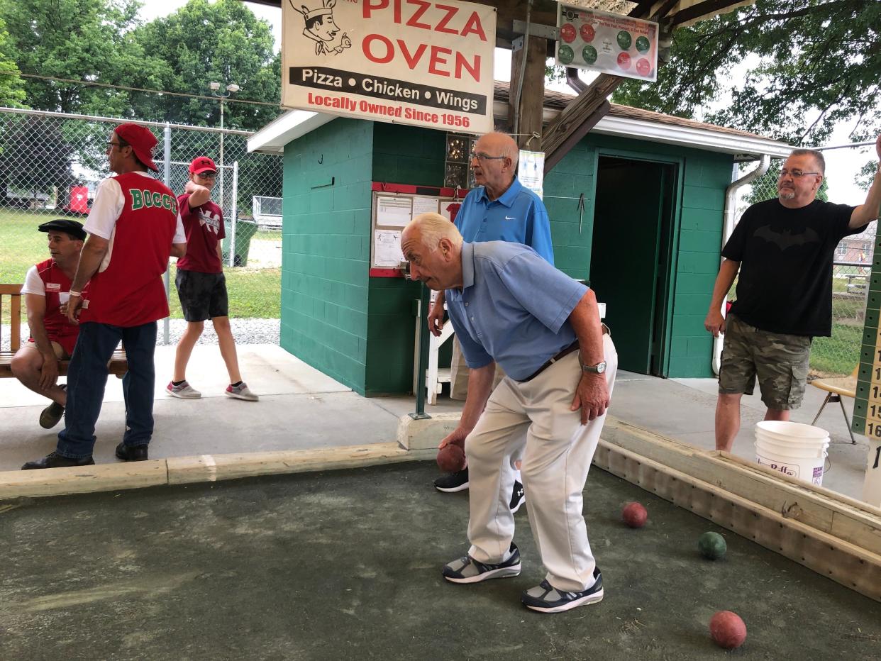 Nick Fierro, 85, practices tossing a bocce ball at the Stark County Italian-American Festival at Weis Park in Canton on Friday evening.