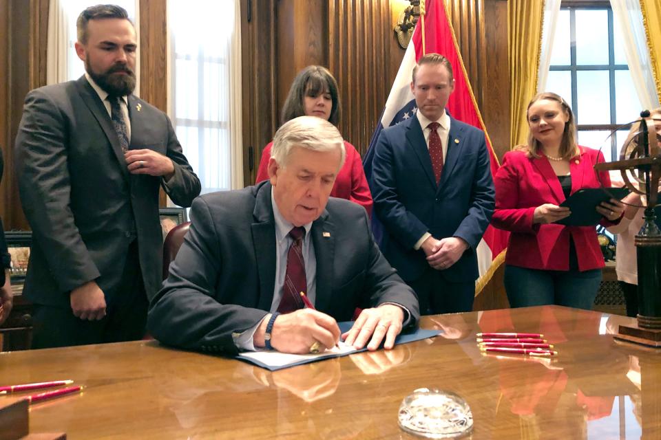 In a May 24, 2019, file photo, Missouri Gov. Mike Parson signs one of the nation's most restrictive abortion bills, banning the procedure on or beyond eight weeks of pregnancy, in Jefferson City.