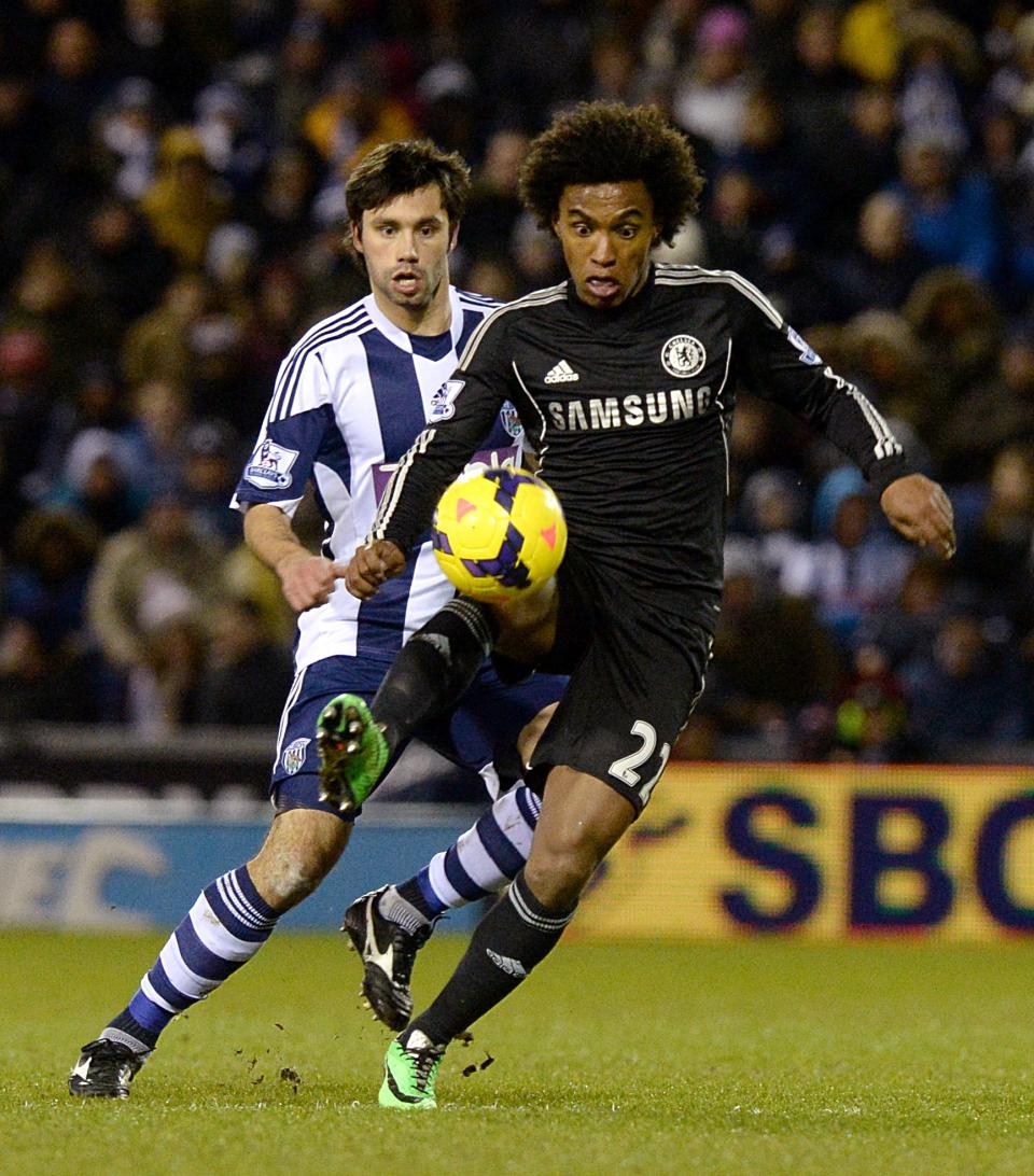 Chelsea's da Silva Willian, right, and West Bromwich Albion's Claudio Yacob in action during their English Premier League match at the The Hawthorns Stadium, West Bromwich England Tuesday Feb. 11, 2014.(AP Photo/ Martin Rickett/PA) UNITED KINGDOM OUT