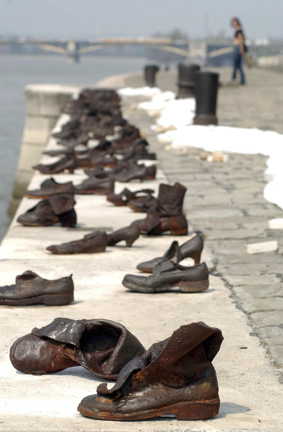 FILE - A view of the monument consisting of 60 contemporary shoes made of cast iron in memory of the Jewish people who were shot into the River Danube by members of the Hungarian Nazi party, the so-called Arrow-Cross Party during World War II, at the quay of the River in Budapest, Friday April 15, 2005. In a video address Friday, March 25, 2022 to a summit of EU leaders, Ukrainian President Volodymyr Zelenskyy made a frank, direct appeal to Hungary Prime Minister Viktor Orban to take a clearer stance on Russia's war on Ukraine and support his besieged country. Zelenskyy recalled that Hungary's capital of Budapest had experienced the horrors of war in the 20th century, and referred to a memorial of bronze shoes on the Danube river that pays tribute to the Hungarian Jews executed by German and Hungarian fascists in World War II. (AP Photo/MTI, Barnabas Honeczy, File )