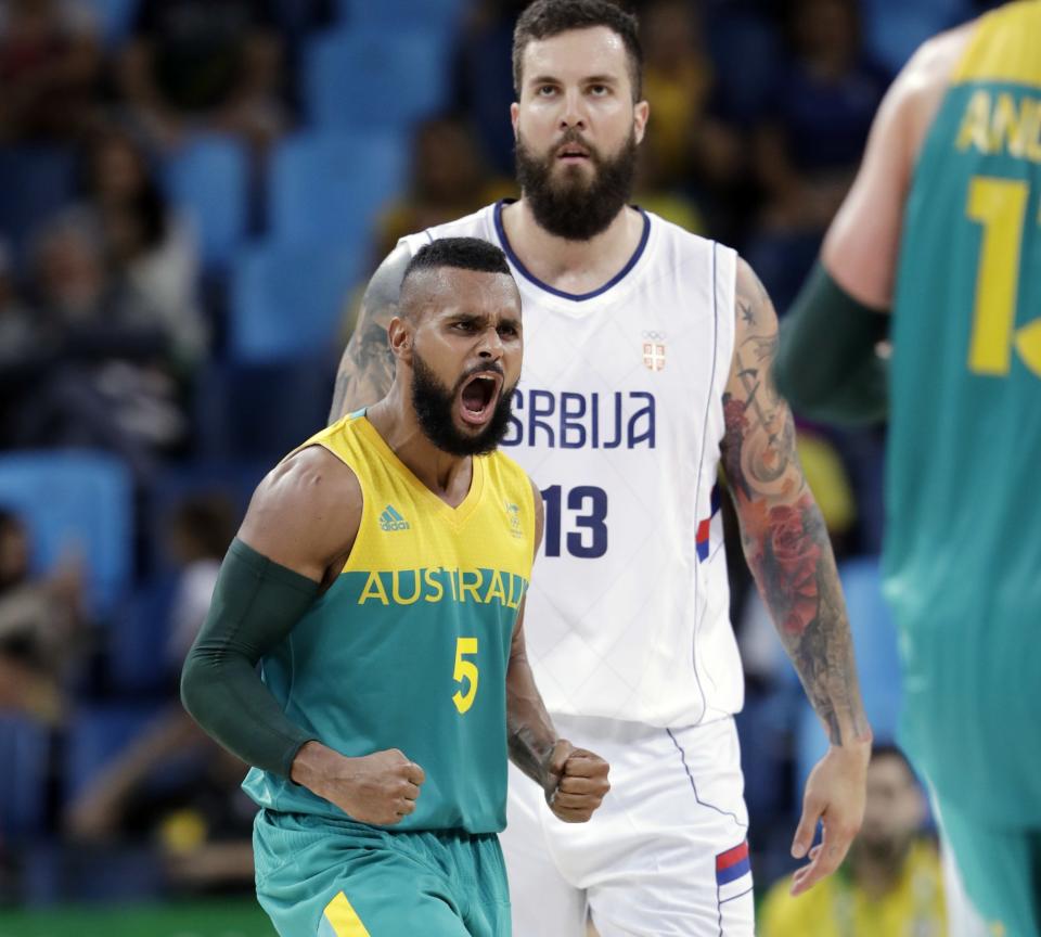 Patty Mills celebrates a score in front of Miroslav Raduljica during Australia's 95-80 win over Serbia at the 2016 Summer Olympics in Rio de Janeiro. (AP/Eric Gay)