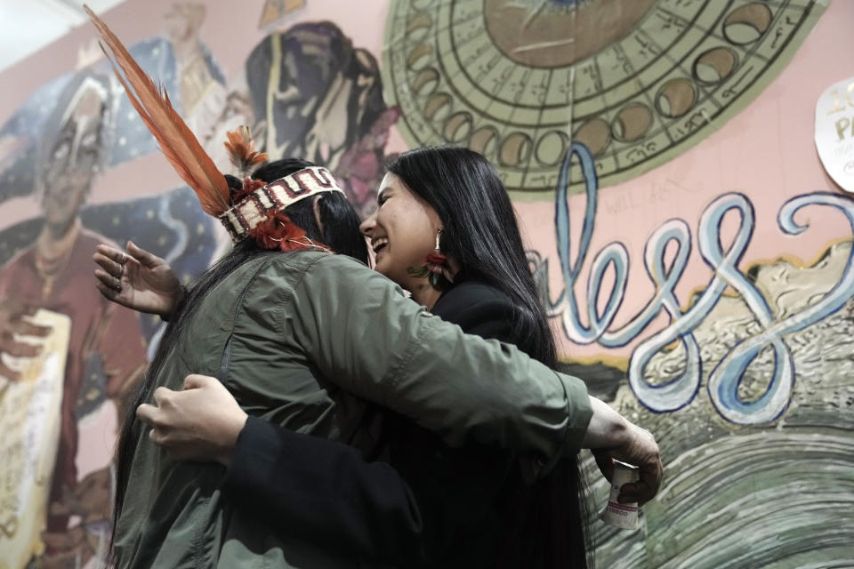 Helena Gualinga, climate activist from Ecuador, right, embraces Gloria Hilda Ushigua Santi, of Ecuador, an elder medicine woman of the Sapara community from the Amazon, at the COP27 U.N. Climate Summit, Wednesday, Nov. 16, 2022, in Sharm el-Sheikh, Egypt. (AP Photo/Nariman El-Mofty)