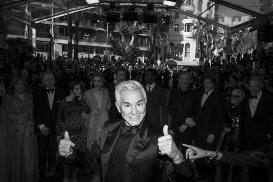 Director Baz Luhrmann, centre, poses for photographers upon arrival at the premiere of the film 'Elvis' at the 75th international film festival, Cannes, southern France, Wednesday, May 25, 2022. (AP Photo/Petros Giannakouris)