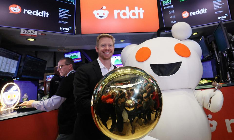 <span>Steve Huffman, CEO of Reddit, stands next to Snoo, the mascot of Reddit, at the New York Stock Exchange.</span><span>Photograph: Brendan McDermid/Reuters</span>