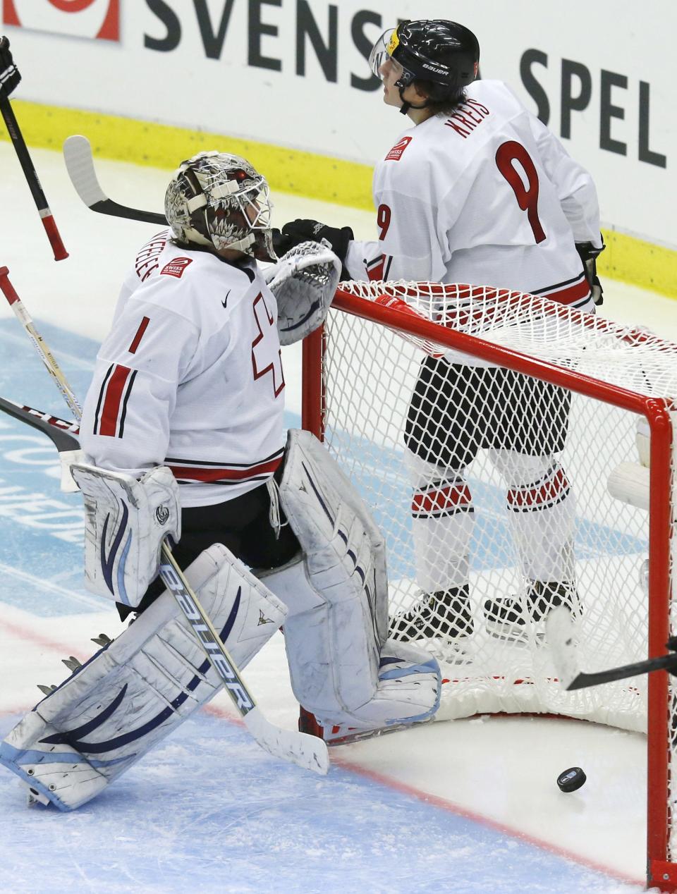 Switzerland's Melvin Nyffeler (L) reacts with teammate Samuel Kreis after giving up a goal to Canada during the third period of their IIHF World Junior Championship ice hockey game in Malmo, Sweden, January 2, 2014. REUTERS/Alexander Demianchuk (SWEDEN - Tags: SPORT ICE HOCKEY)