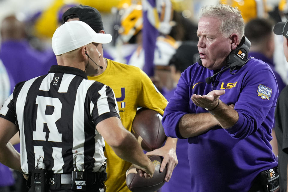LSU head coach Brian Kelly, right, has a discussion with referee Derek Anderson during the first half of an NCAA college football game against Florida State, Sunday, Sept. 3, 2023, in Orlando, Fla. (AP Photo/John Raoux)