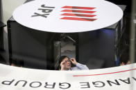 A Tokyo Stock Exchange worker reacts during the morning trading in Tokyo, Tuesday, March 10, 2020. Asian stock markets are taking a breather from recent declines. Several benchmarks gained more than 1% on Tuesday after New York futures reversed on news that President Donald Trump plans to ask Congress for a tax cut and other quick measures to ease the pain of the virus outbreak.(AP Photo/Koji Sasahara)