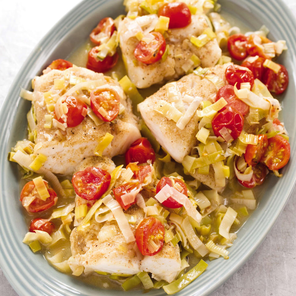 This undated photo provided by America's Test Kitchen in March 2019 shows Braised Cod With Leeks in Brookline, Mass. This recipe appears in the cookbook "How to Braise Everything." (Daniel J. van Ackere/America's Test Kitchen via AP)