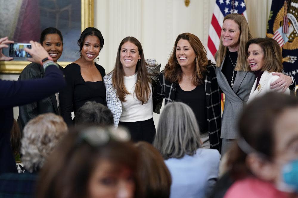 Former members and members of the U.S. Women’s National soccer team, from left, Briana Scurry, Margaret ‘Midge’ Purce, Kelley O’Hara, Julie Foudy, and Cindy Parlow Cone, President of U.S. Soccer, pose for a photo with House Speaker Nancy Pelosi of Calif., before an event to celebrate Equal Pay Day and Women’s History Month in the East Room of the White House, Tuesday, March 15, 2022, in Washington. (AP Photo/Patrick Semansky, File)