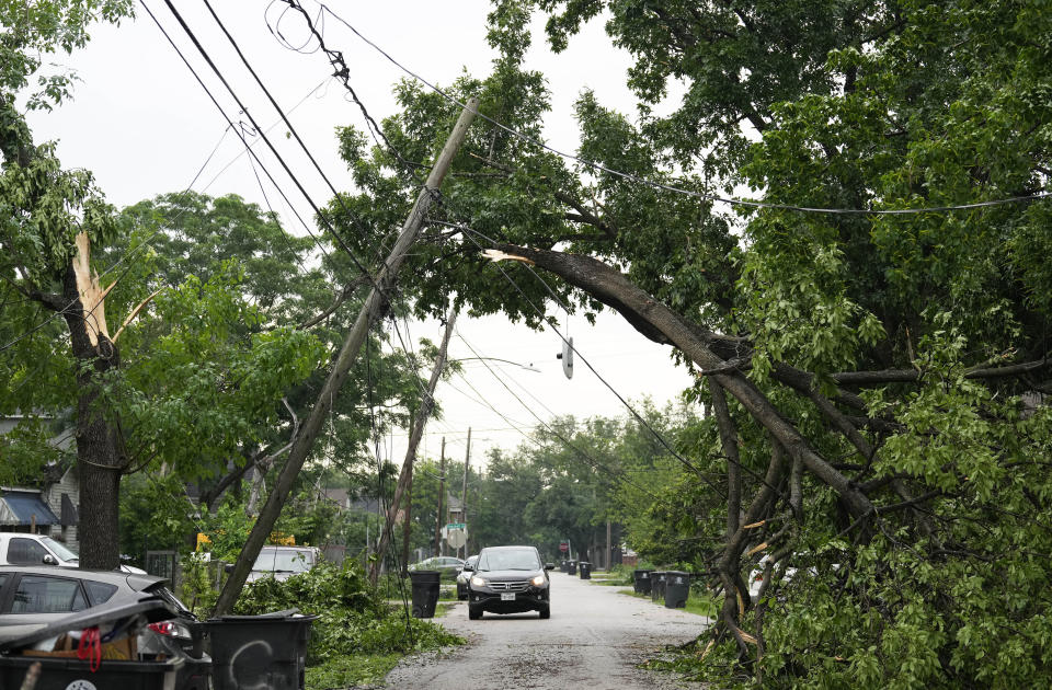 A tree snapped and tangled with the power wires on Gentry Street on Friday, May 17, 2024 in Northeast Houston. (Yi-Chin Lee/Houston Chronicle via AP)