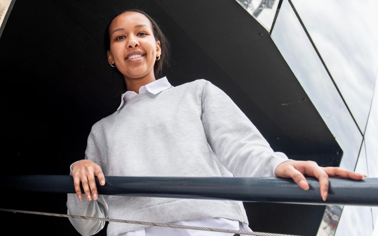 Nimo Mohamed, who did a degree in accounting and finance but retrained as a software engineer, and is pictured outside Lloyds Bank where she is doing a placement project